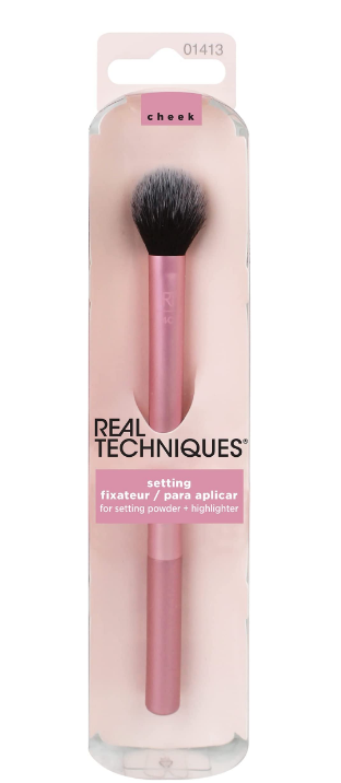 A makeup brush is used to highlight blush